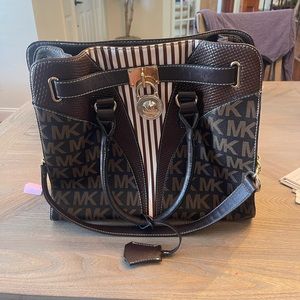 Michael Kors Brown Leather Purse with lock and key. Great condition.